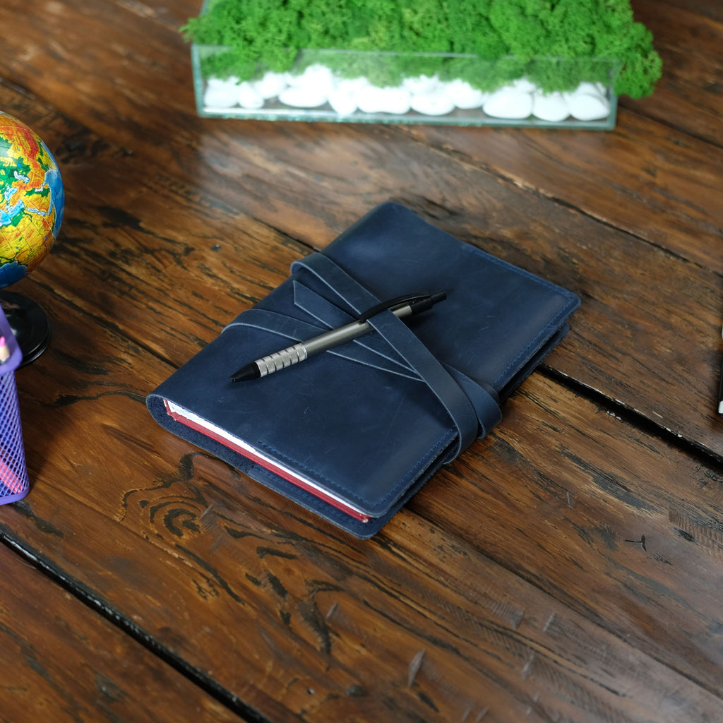 Leather cover with a tie around the notebook